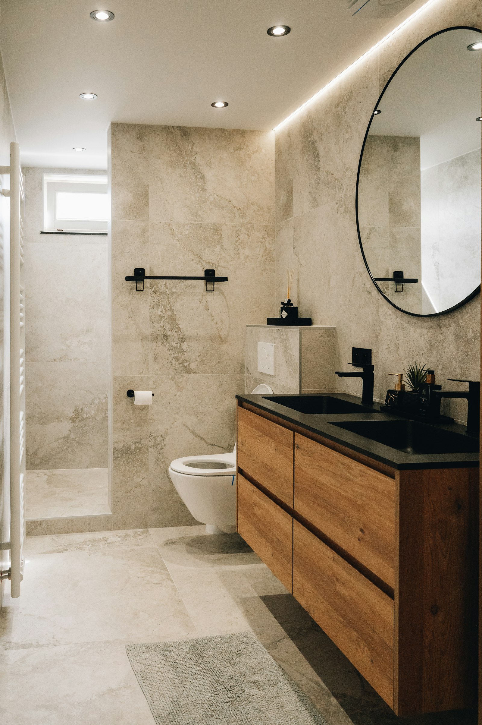 Renovated bathroom with walk-in tile shower and vanity