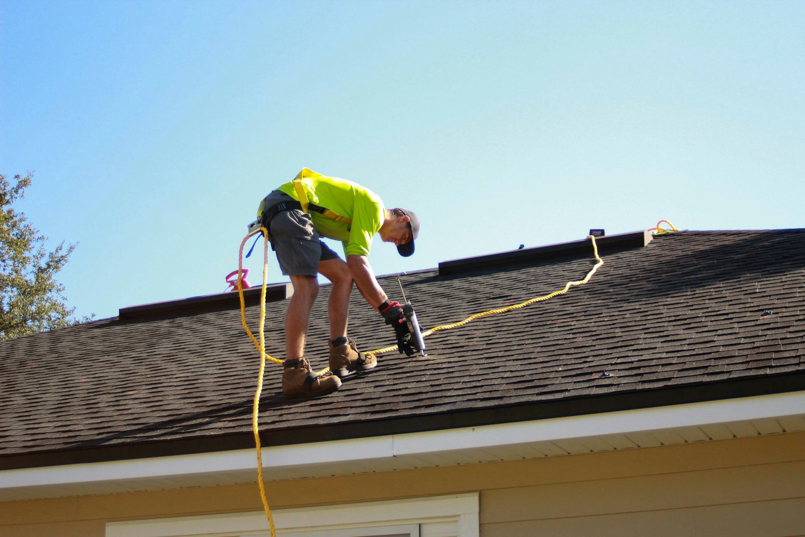 Costa Construction & Engineering roofer repairing shingles on a Cape Coral, FL home